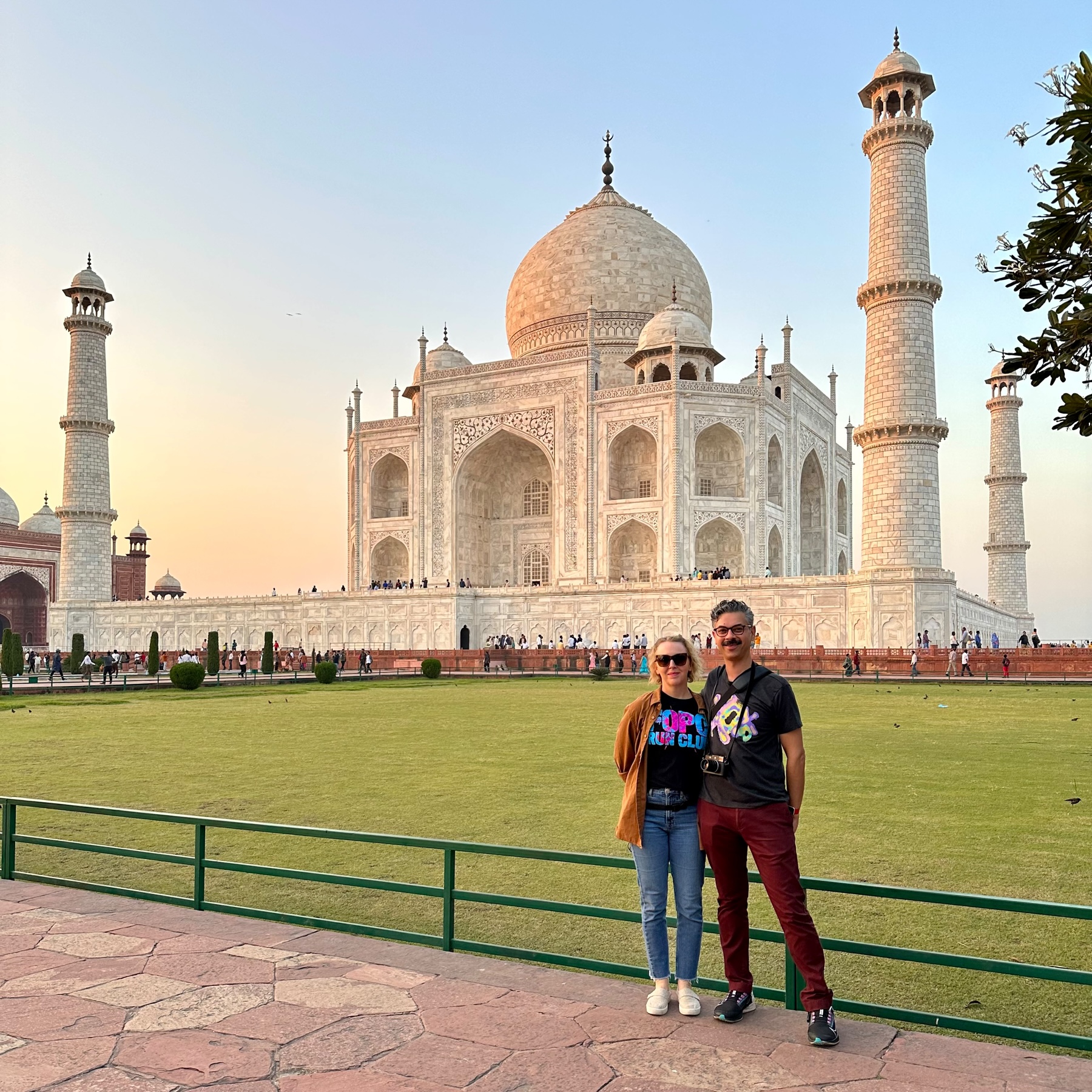 Jenni and I in front of the Taj Mahal which is glowing in sunset yellow-orange color.